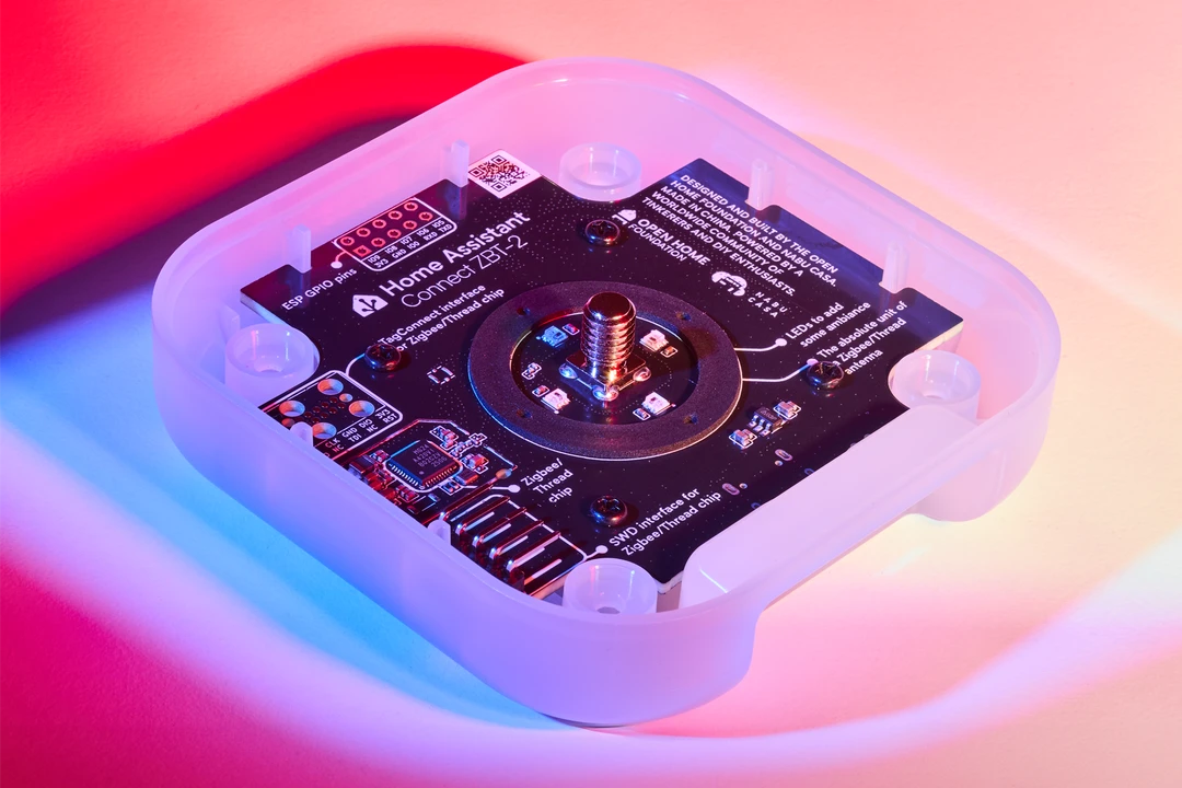 A wide lifestyle shot of a room, with the Home Assistant Connect ZBT-2 device next to a Home Assistant ZWA-2 on a black side table against a green paneled wall.